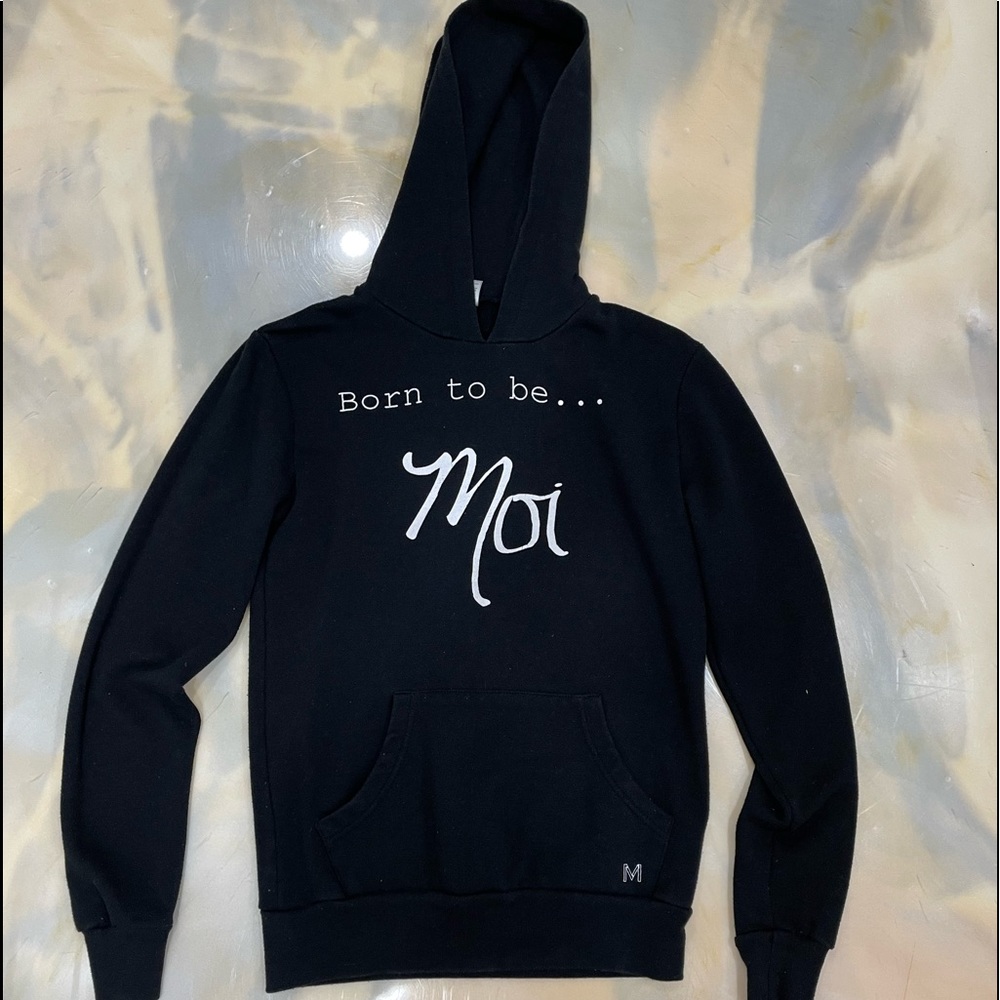 Black hoodie with "Born to be Moi".